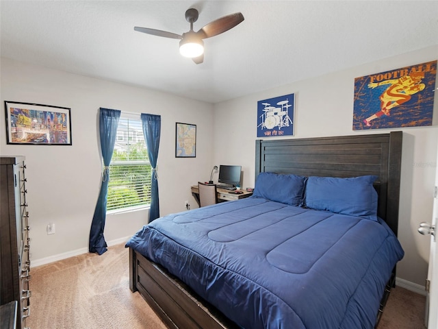 carpeted bedroom featuring a ceiling fan and baseboards