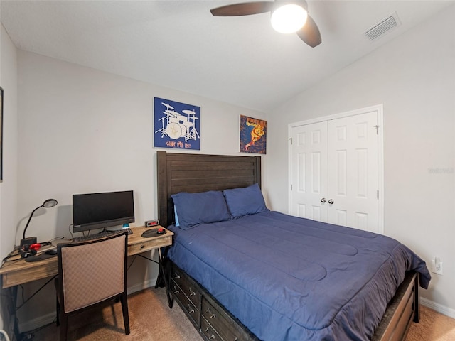 bedroom with visible vents, a ceiling fan, a closet, light colored carpet, and vaulted ceiling