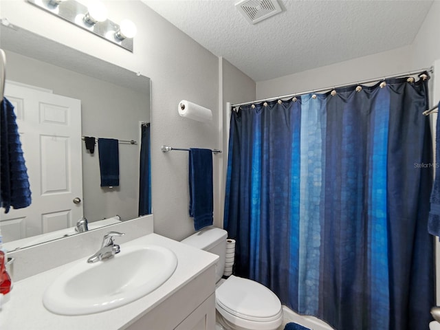 bathroom featuring visible vents, toilet, vanity, a shower with shower curtain, and a textured ceiling