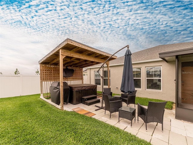 view of patio / terrace with a gazebo, area for grilling, a hot tub, and fence