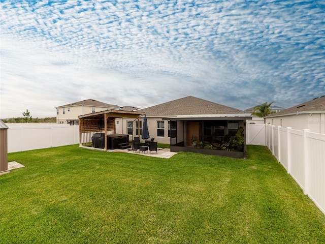 rear view of house featuring a patio, a yard, a fenced backyard, and a shingled roof