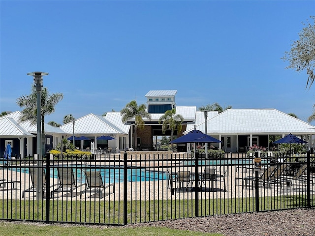 community pool featuring a patio area and fence