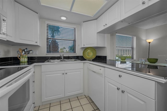 kitchen with white cabinets, white appliances, and a healthy amount of sunlight