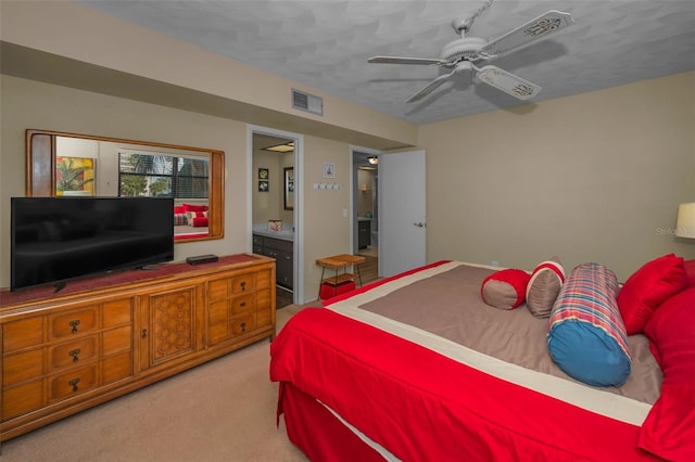 bedroom with visible vents, connected bathroom, a ceiling fan, and carpet