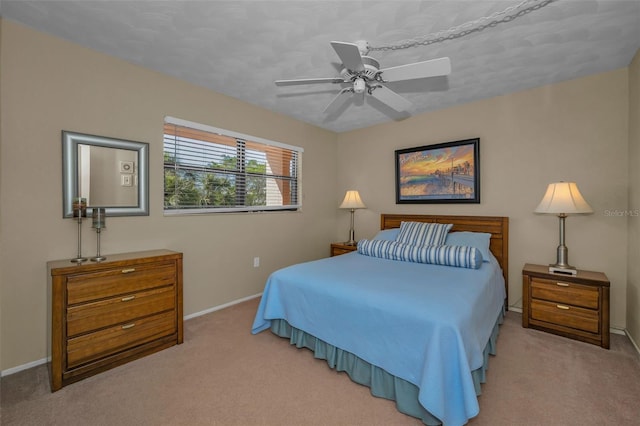 bedroom featuring baseboards, carpet floors, and ceiling fan