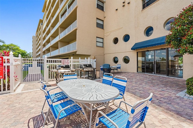 view of patio / terrace featuring grilling area and fence