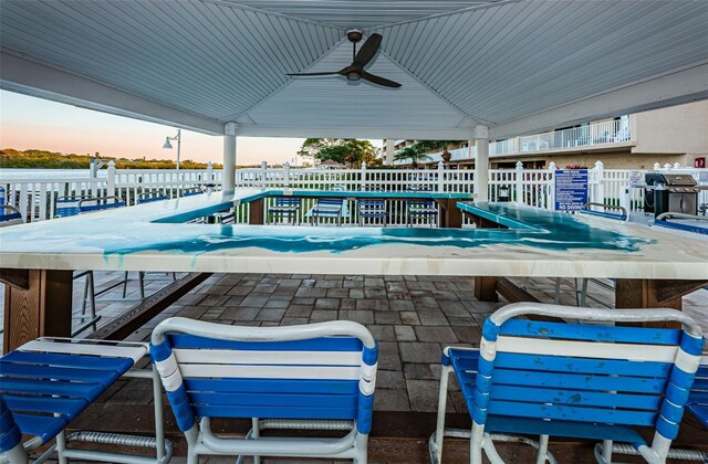 view of pool with ceiling fan and fence