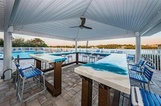 view of patio / terrace featuring a community pool and a ceiling fan