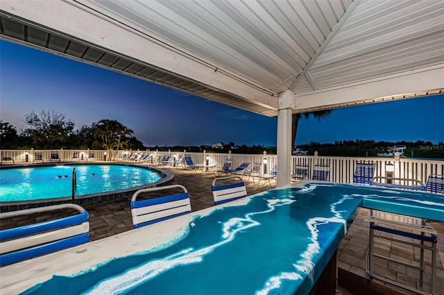 community pool featuring a patio area and fence