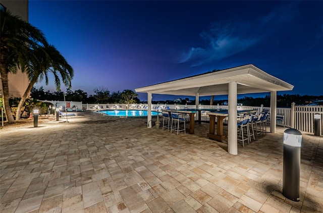 view of patio / terrace with a community pool and fence