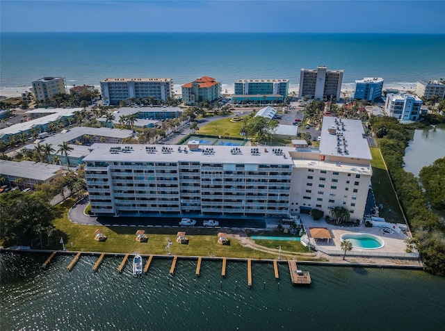 birds eye view of property with a water view and a city view