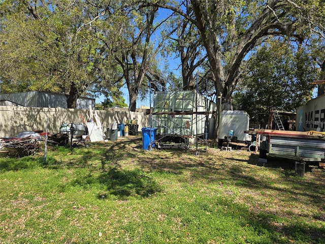 view of yard featuring an outdoor structure and fence