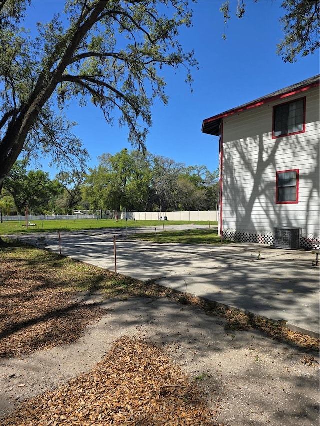 exterior space featuring driveway and fence