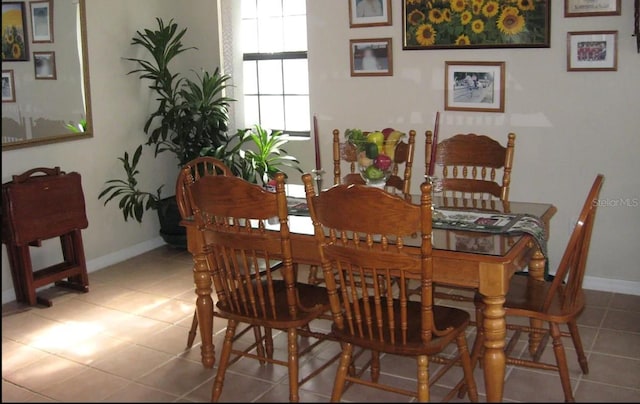 dining room with tile patterned floors and baseboards