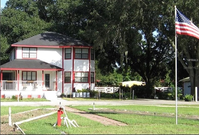 view of front of home with a porch and a front lawn