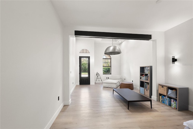 living area with wood finished floors and baseboards