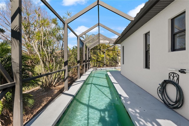 view of swimming pool featuring a lanai and a patio area