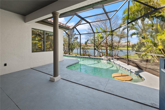 outdoor pool with glass enclosure, a water view, and a patio area