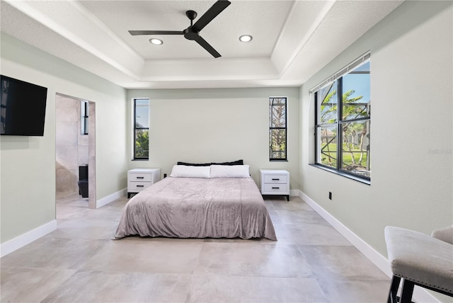 bedroom featuring recessed lighting, a ceiling fan, a raised ceiling, and baseboards