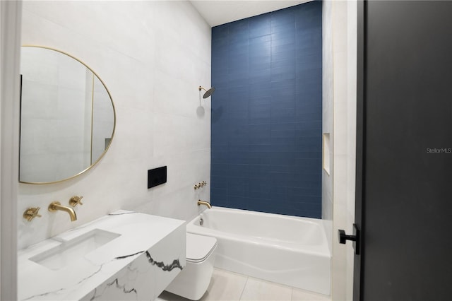 bathroom featuring toilet, tile walls, tile patterned flooring, bathing tub / shower combination, and vanity