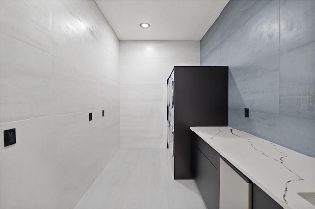 bathroom with recessed lighting, tile walls, and tile patterned flooring