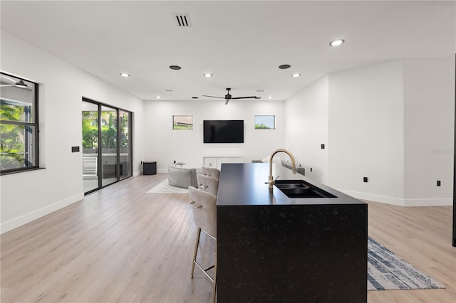 3635 80th Dr E, Sarasota, FL 34243 - kitchen with a sink, light wood-type flooring, open floor plan, visible vents, and ceiling fan