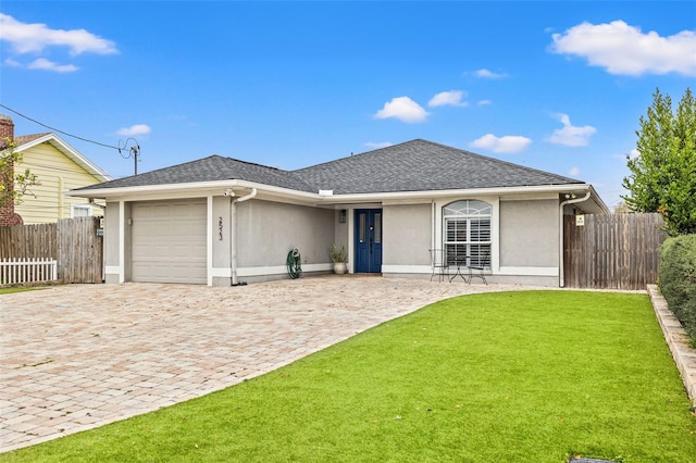 ranch-style home featuring decorative driveway, fence, a garage, and stucco siding