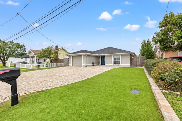 ranch-style home with stucco siding, decorative driveway, fence, a front yard, and a garage