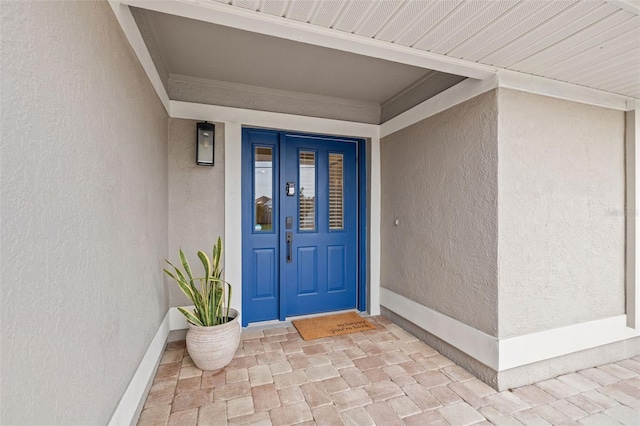 property entrance featuring stucco siding