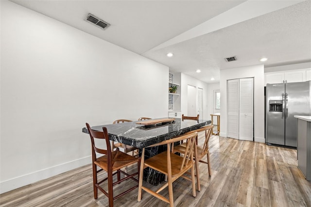 dining room with visible vents, recessed lighting, baseboards, and light wood-style floors