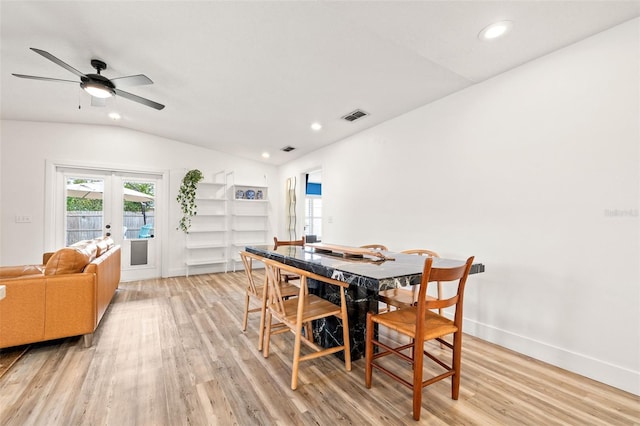 dining space featuring light wood finished floors, visible vents, recessed lighting, and vaulted ceiling