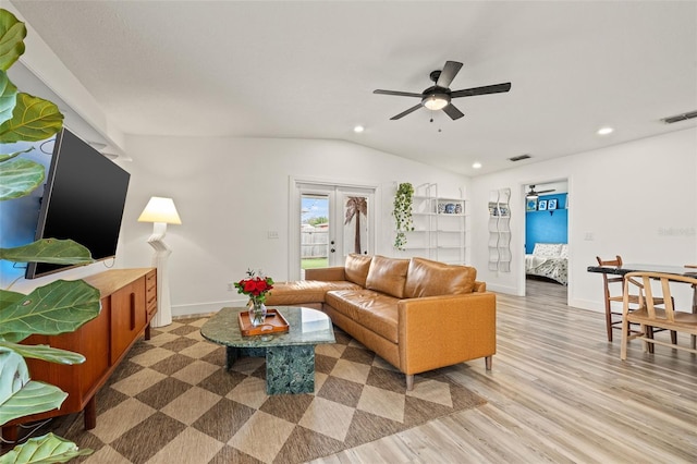 living room featuring visible vents, vaulted ceiling, recessed lighting, light wood-style flooring, and french doors