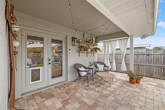 view of patio featuring fence and french doors