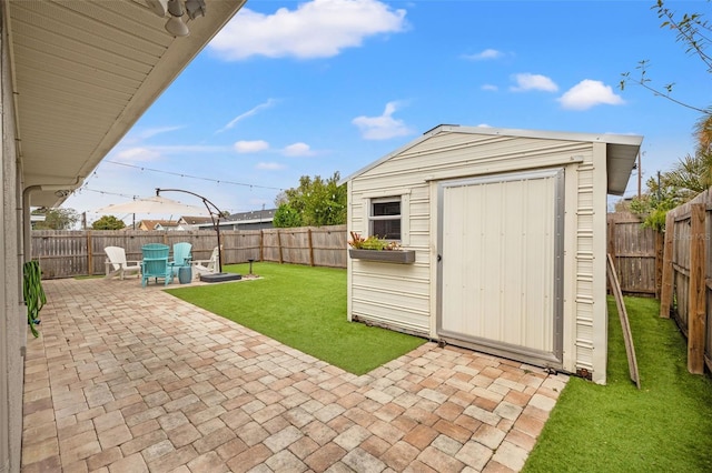 exterior space featuring an outbuilding, a storage unit, and a fenced backyard