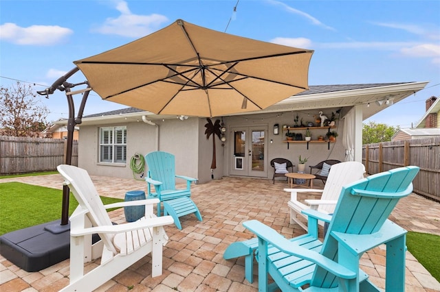 view of patio with french doors and a fenced backyard