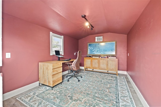 office area with baseboards, lofted ceiling, and wood finished floors