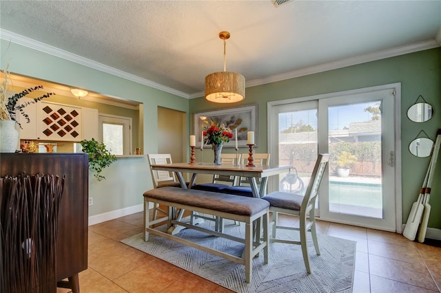 dining space with visible vents, crown molding, baseboards, light tile patterned floors, and a textured ceiling