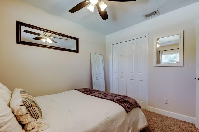 carpeted bedroom featuring a closet, visible vents, a ceiling fan, and baseboards