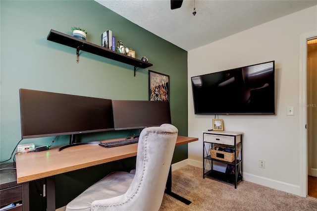 carpeted office featuring ceiling fan and baseboards