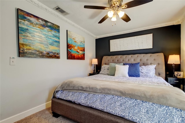 carpeted bedroom with ceiling fan, baseboards, visible vents, and ornamental molding