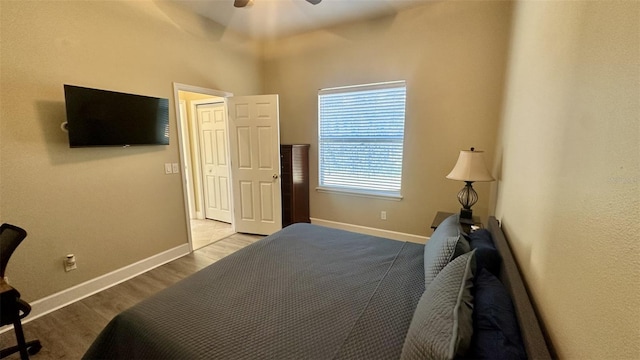 bedroom with ceiling fan, baseboards, and wood finished floors