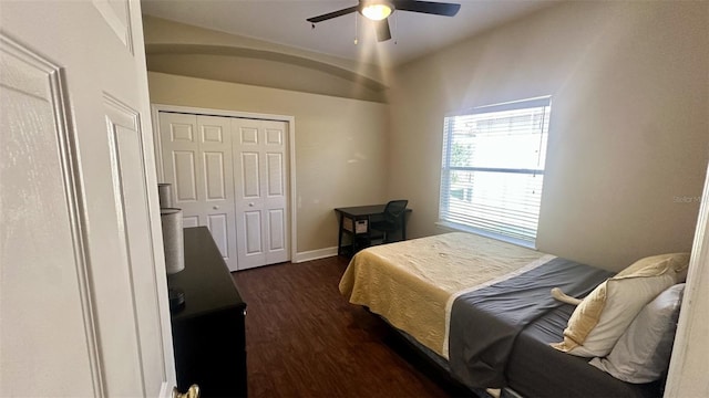 bedroom with ceiling fan, a closet, baseboards, and dark wood finished floors