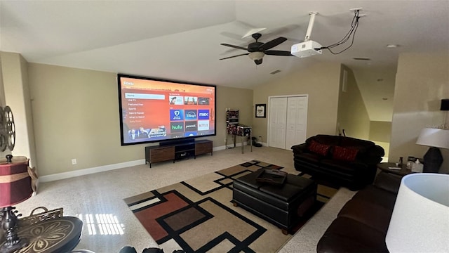 living area featuring carpet flooring, baseboards, lofted ceiling, and a ceiling fan