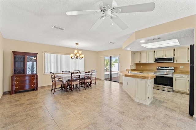 kitchen with decorative light fixtures, visible vents, stainless steel appliances, and a sink