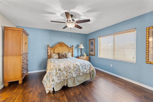 bedroom with dark wood-style floors, a textured ceiling, baseboards, and a ceiling fan