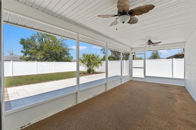 unfurnished sunroom with a ceiling fan