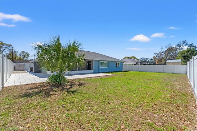 back of house with a patio area, a lawn, and a fenced backyard