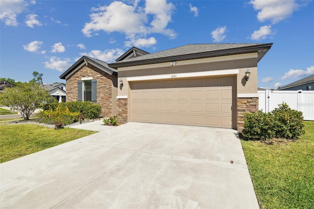 view of front of house with stucco siding, stone siding, a garage, and concrete driveway