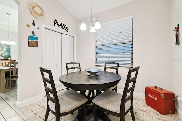 dining space featuring baseboards, an inviting chandelier, and wood tiled floor