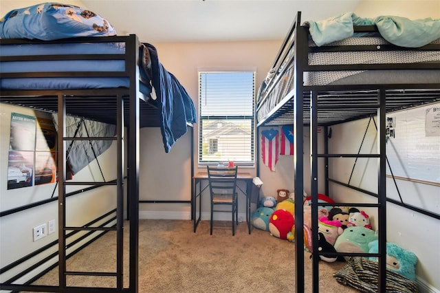 bedroom with baseboards and carpet